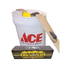 a bucket with some tools in it next to a piece of wood and a box