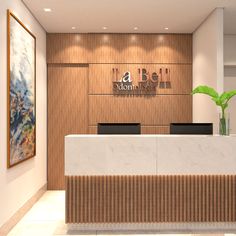 an office lobby with marble counter tops and wood paneling on the walls, along with a plant in a vase