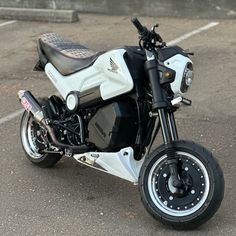 a white and black motorcycle parked in a parking lot