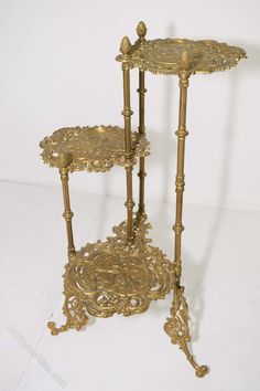 an ornately decorated table with two tiered trays on each side and a candle holder in the middle