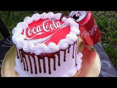 a coca - cola cake with white frosting and chocolate icing