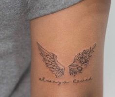 a woman with a tattoo on her arm that says, always love and two wings