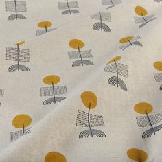 an image of a white fabric with yellow and black trees on it's surface