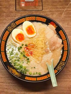 a bowl of ramen topped with hard boiled eggs