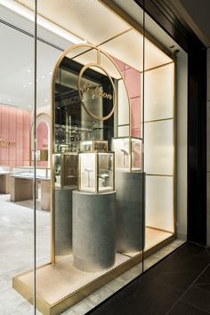 the entrance to a luxury jewelry store with large glass windows and gold trimmings