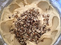 a mixing bowl filled with batter and nuts