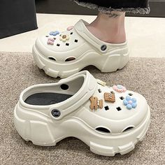 Elevate your footwear collection with these White High Platform Crocs Like Sandals Shoes. Designed with a cute aesthetic in mind, these shoes feature a cream-white color that complements various outfits. Crafted from high-quality EVA material, they offer both durability and comfort, ensuring long-lasting wear. The platform design adds extra height and a trendy touch to your look. Free shipping in the US and worldwide. What sets these sandals apart are the adorable flower charms that decorate them. These charming embellishments add a playful and whimsical element to your ensemble, making them perfect for expressing your unique style. Whether you're into cute aesthetics, softie outfits, or kawaii fashion, these platform Crocs are a must-have. High-Quality EVA Material - Provides durability a White Crocs Aesthetic, Crocs Aesthetic Outfit, Softie Outfits, Cute Crocs Shoes, Crocs Aesthetic, Crocs With Charms, Crocs Platform, Cute Aesthetics, Crocs Outfit