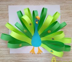 a paper peacock with green and yellow strips