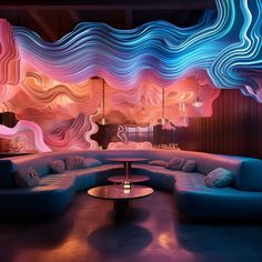 a living room filled with blue couches next to a wall covered in colorful waves