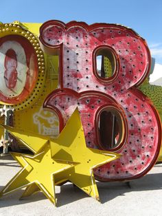 a large neon sign with the number six on it's side and stars in front of it