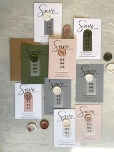 the wedding stationery is laid out on top of each other, with different buttons