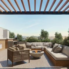 an outdoor living area with couches, chairs and fire pit in the middle of it