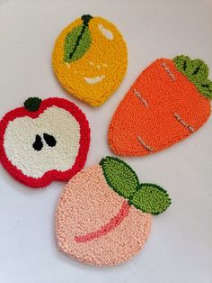 three coasters with fruit and vegetables on them