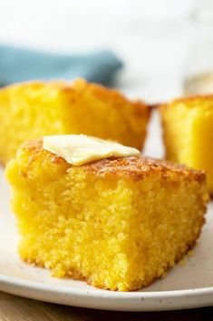 two pieces of cornbread on a white plate