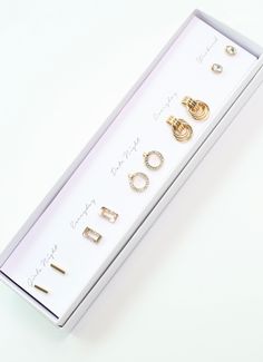 This boxed earring set includes five pairs of earrings to match with any outfit. It has a great mix of basic essentials and hints of sparkle. This is a wonderful accessory to give as a gift as well! Dimensions: all under 0.75" Hand-set Yellow Gold Earrings Gift, Gold Alloy Clip-on Earrings For Gifts, Glamorous Sparkling Stones Clip-on Earrings For Gift, Basic Essentials, Studded Necklace, Hair Sale, Earring Sale, Ring Collections, Bow Headband