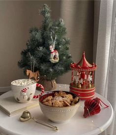 a bowl of cereal sits on a table next to a christmas tree and other decorations