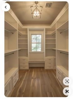 an empty walk in closet with drawers and shelves