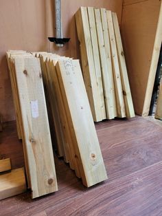 several pieces of wood sitting next to each other on the floor in front of a wall