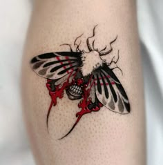 a close up of a person's leg with a tattoo design on the thigh