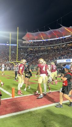 the football players are running onto the field