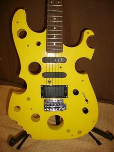 a yellow electric guitar sitting on top of a table