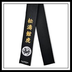 a black karate belt with gold writing on the front and side, in chinese characters