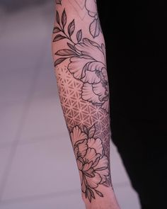 a person with a flower tattoo on their arm