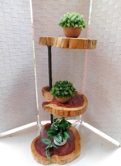 three tiered wooden plant stand with potted plants