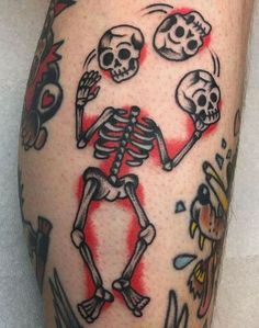 a man's leg with tattoos on it and two skulls in the middle of his legs