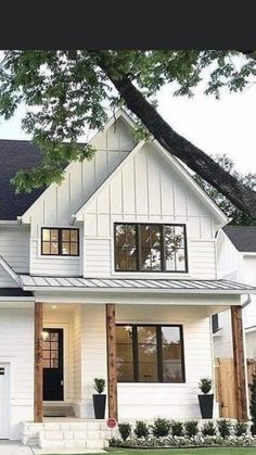 a white house with black roof and windows