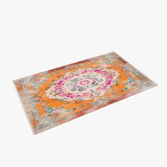 an orange and pink area rug on a white background with a floral design in the middle