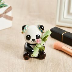 a small panda bear figurine sitting on top of a table