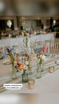 several vases with flowers are sitting on a table