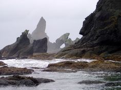 some rocks and water on a cloudy day