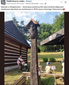 a man sitting in a chair next to a wooden pole with a birdhouse on it