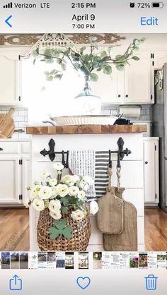 the kitchen is decorated with white flowers and wooden utensils