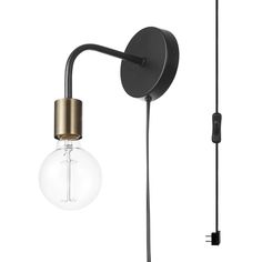 a black and gold wall light next to a bulb