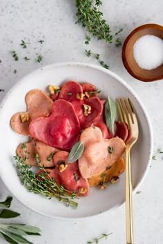 a white plate topped with meat and vegetables