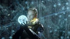 a man holding a crystal ball in his hand