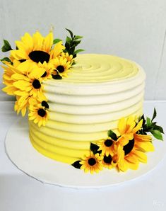 a yellow cake with sunflowers on top