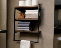 towels are stacked on shelves in the bathroom