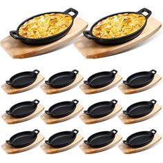 twelve cast iron skillets with wooden trays and serving plates on white background photo