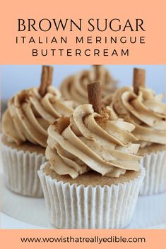 some cupcakes with icing and cinnamon sticks in them on a white plate