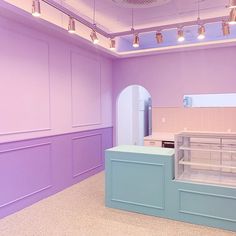 an empty kitchen with purple walls and blue counter tops in a room that has no one inside