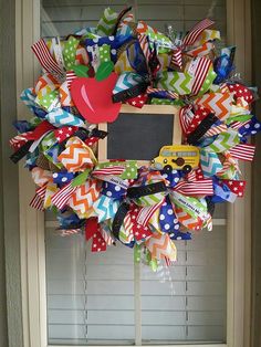 a school bus themed wreath hanging on the front door