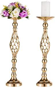 two gold candlesticks with flowers and a white candle on the top one is holding a lit candle