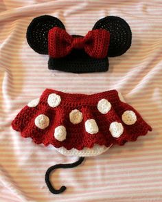 two crocheted minnie mouse ears and a red skirt with white polka dots on them