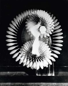 a black and white photo of a sculpture made out of paper fan shaped like a woman