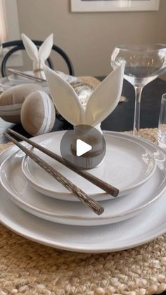 the table is set with white plates and silverware