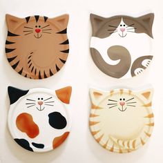 three plates with cats painted on them